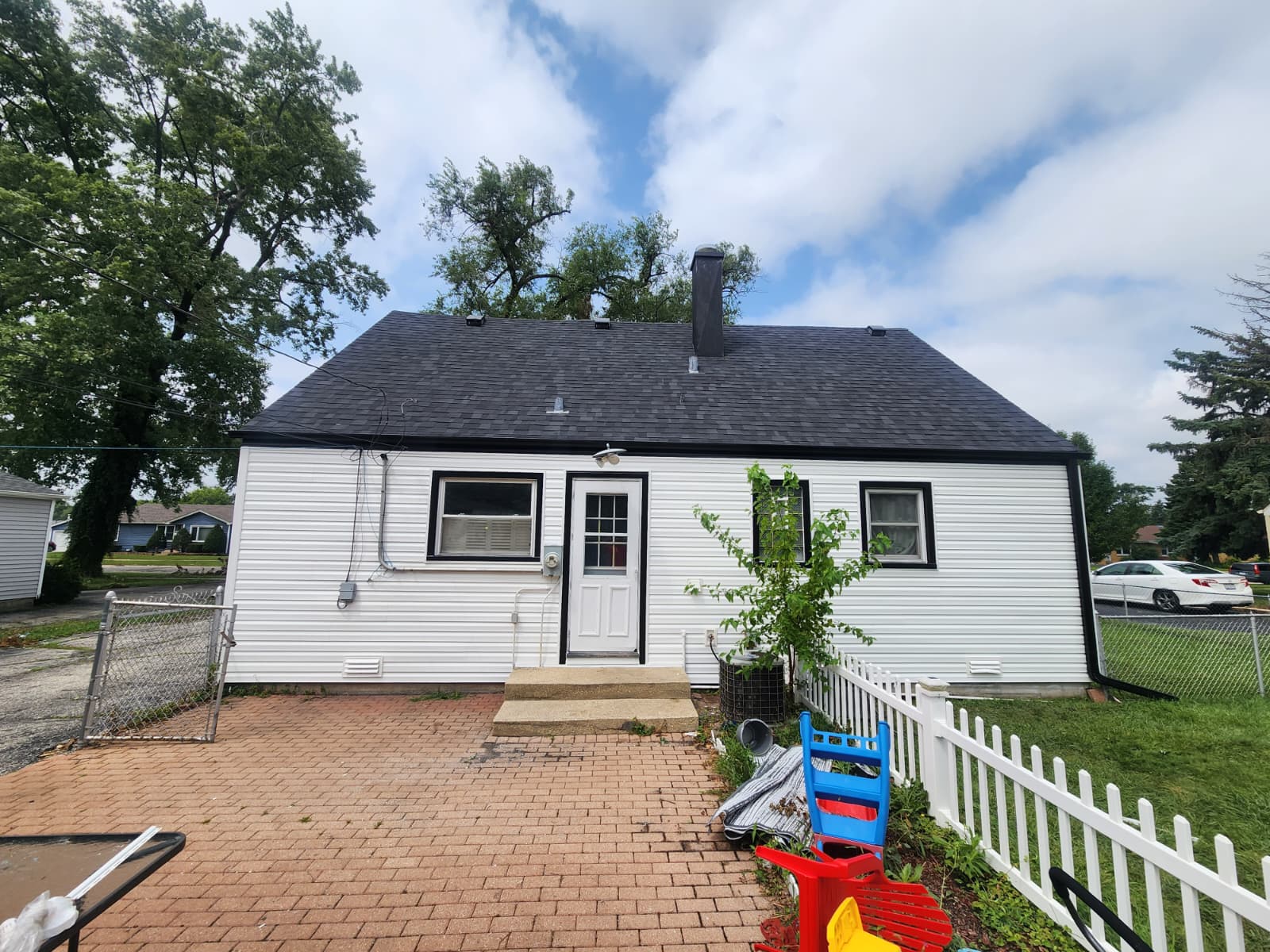Rear elevation with new white vinyl siding and black trim — Burbank, IL