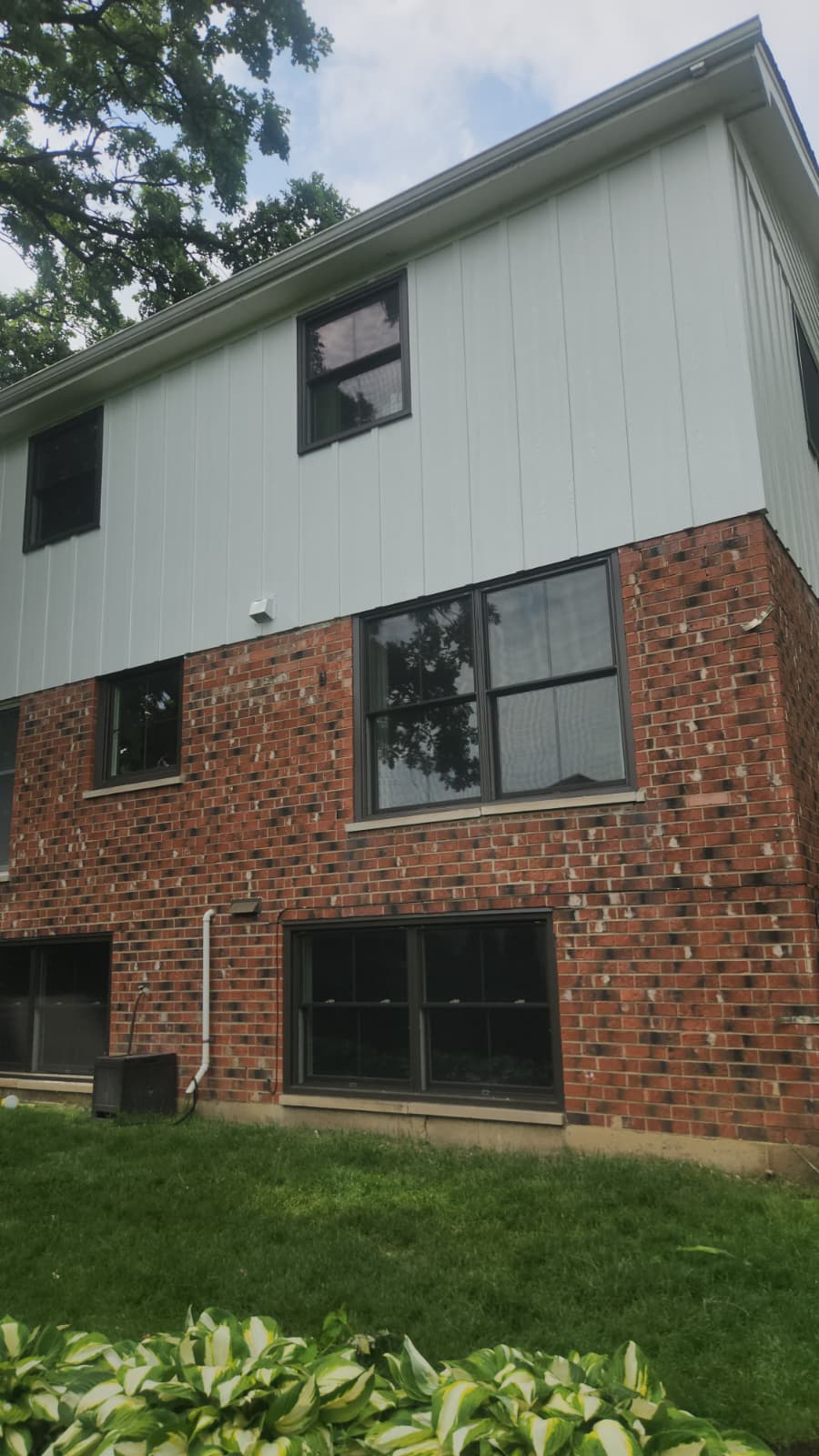 Oak Lawn split-level home after vertical board & batten siding replacement