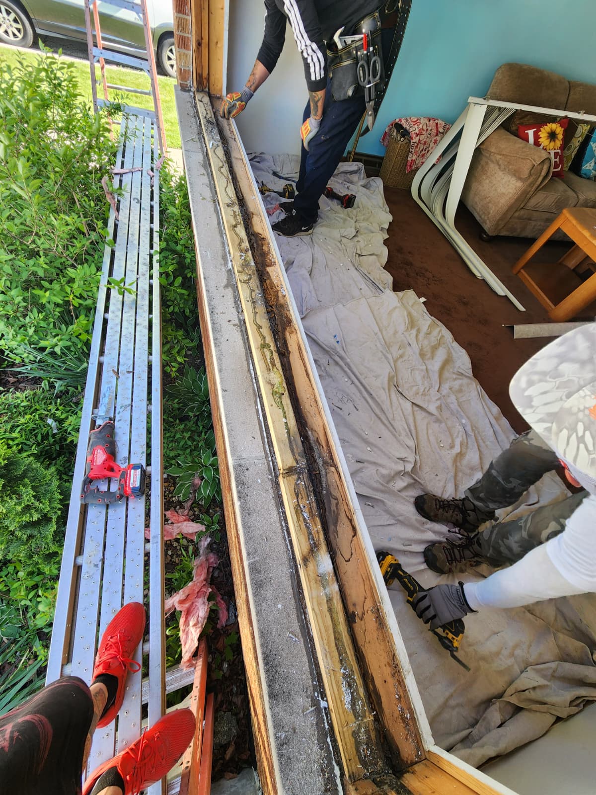 Rotted sill plate and framing exposed after window tear-out